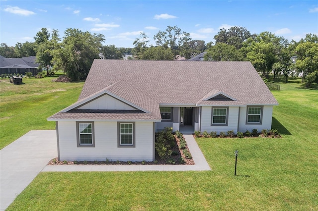 2569 Rogers Rd, Lakeland, FL 33812 - ranch-style house with a front yard, roof with shingles, and board and batten siding