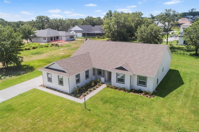 2569 Rogers Rd, Lakeland, FL 33812 - ranch-style house with roof with shingles, a front lawn, and a residential view