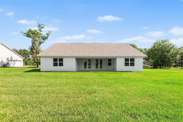 2569 Rogers Rd, Lakeland, FL 33812 - back of property with french doors, stucco siding, a lawn, and a shingled roof