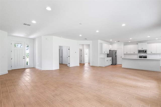 2569 Rogers Rd, Lakeland, FL 33812 - unfurnished living room featuring recessed lighting and light wood-type flooring