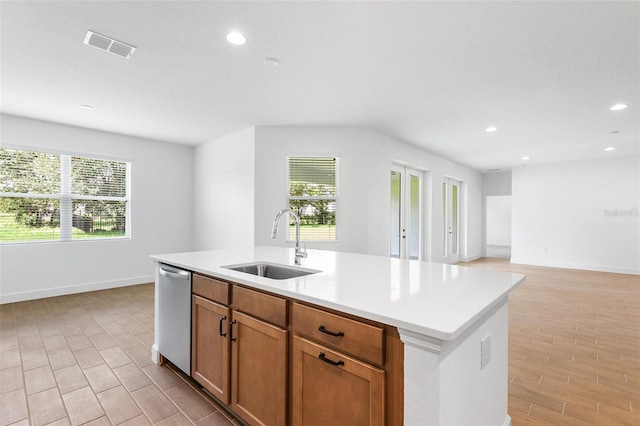 2569 Rogers Rd, Lakeland, FL 33812 - kitchen featuring stainless steel dishwasher, light wood-type flooring, recessed lighting, a kitchen island with sink, and healthy amount of natural light