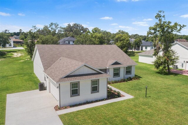 2569 Rogers Rd, Lakeland, FL 33812 - view of front of house with driveway, a shingled roof, a front yard, a garage, and a residential view
