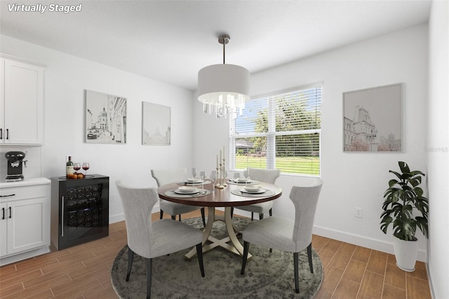 2569 Rogers Rd, Lakeland, FL 33812 - dining space with wood finish floors, beverage cooler, and a chandelier