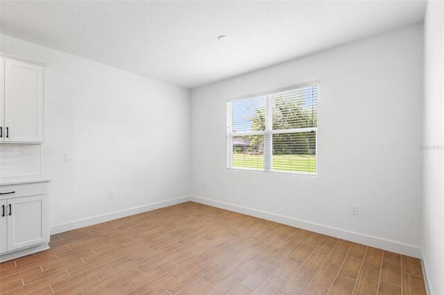 2569 Rogers Rd, Lakeland, FL 33812 - unfurnished room with light wood-style floors and baseboards
