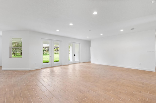 2569 Rogers Rd, Lakeland, FL 33812 - spare room featuring recessed lighting, light wood-type flooring, and french doors