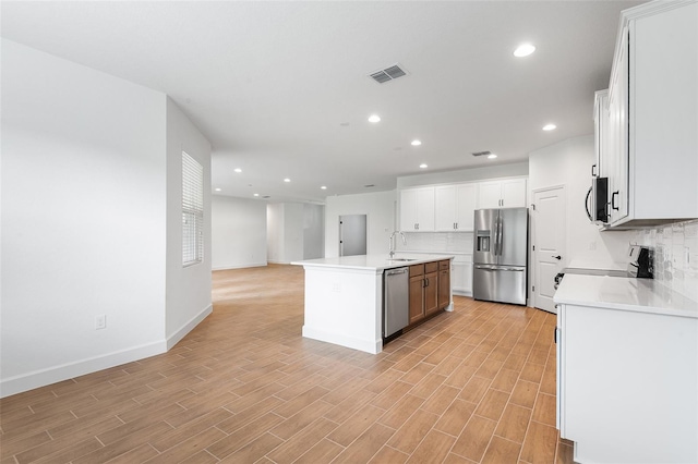 2569 Rogers Rd, Lakeland, FL 33812 - kitchen with stainless steel appliances, tasteful backsplash, recessed lighting, an island with sink, and open floor plan