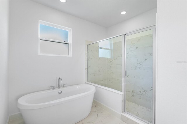 2569 Rogers Rd, Lakeland, FL 33812 - full bathroom with a freestanding tub, a marble finish shower, recessed lighting, and marble look tiles