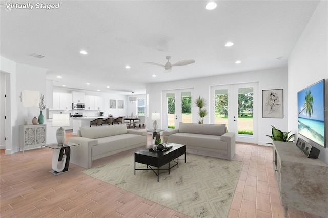 2569 Rogers Rd, Lakeland, FL 33812 - living room with light wood finished floors, recessed lighting, a ceiling fan, and french doors