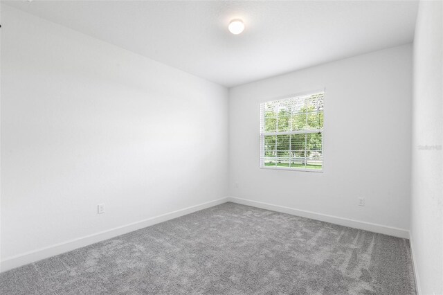 2569 Rogers Rd, Lakeland, FL 33812 - unfurnished room featuring carpet floors and baseboards