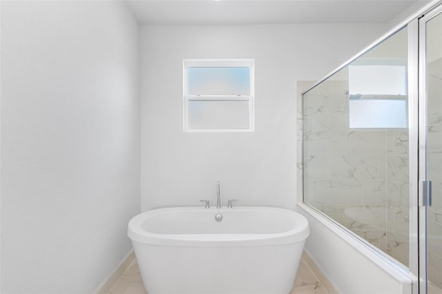 2569 Rogers Rd, Lakeland, FL 33812 - full bath featuring a freestanding tub, healthy amount of natural light, a shower stall, and marble finish flooring