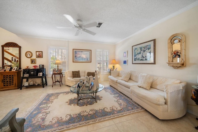 tiled living room with a textured ceiling, ornamental molding, visible vents, and a ceiling fan