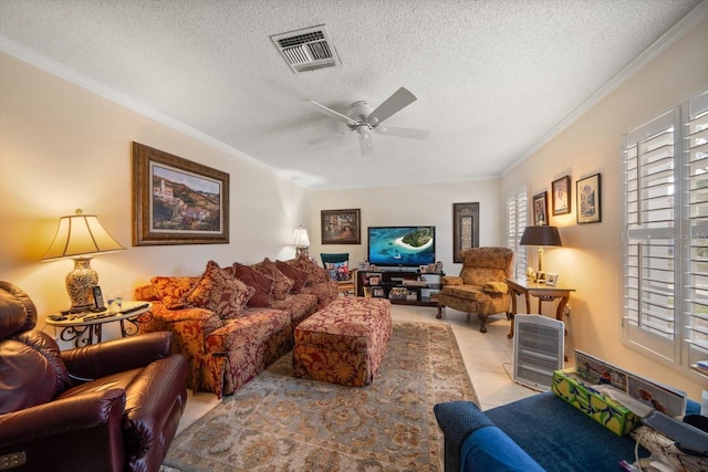 living area featuring a textured ceiling, visible vents, and crown molding