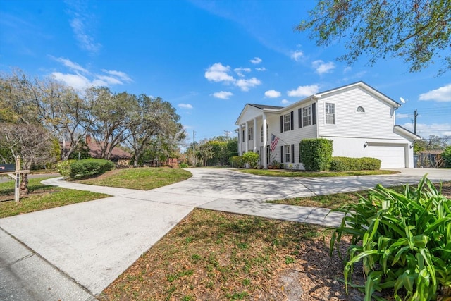 view of front of house featuring a garage, a front yard, and driveway