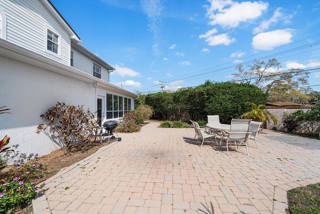 view of patio featuring outdoor dining area, fence private yard, and a grill