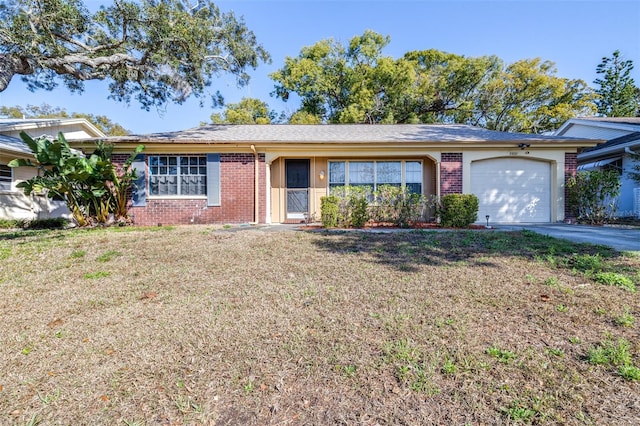 ranch-style home with a front lawn and a garage