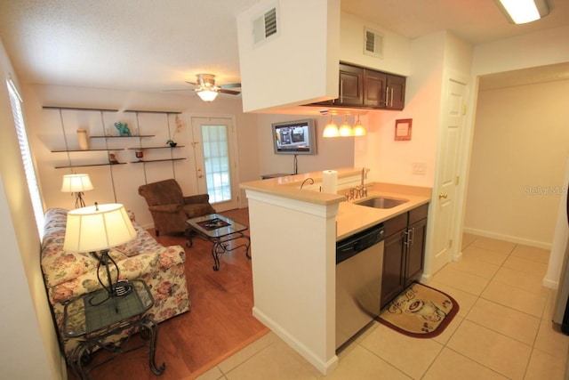 kitchen featuring sink, light tile patterned flooring, ceiling fan, stainless steel dishwasher, and dark brown cabinets