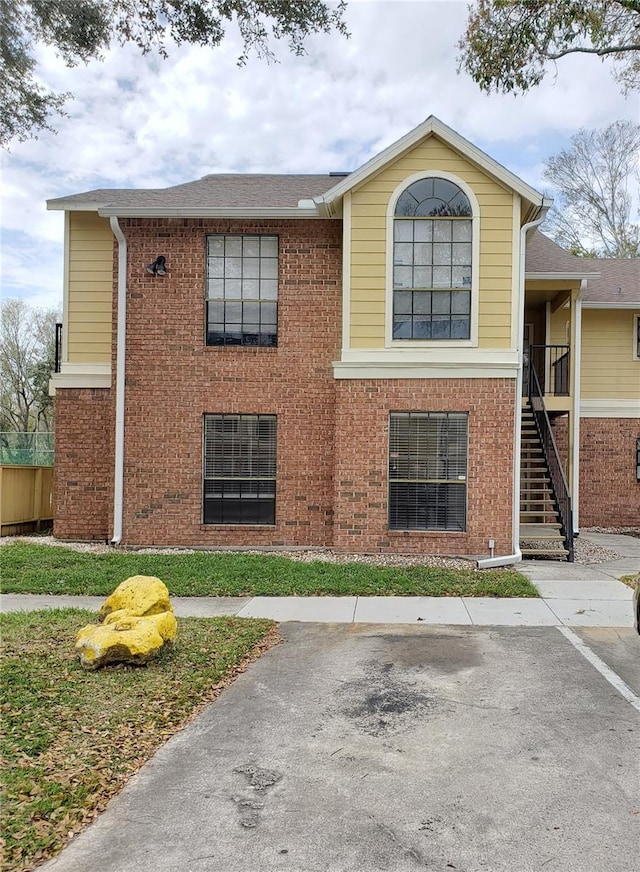 exterior space with stairs and brick siding