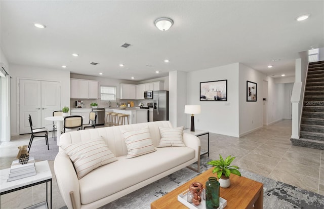 10352 Cross River Trl, Parrish, FL 34219 - living room featuring stairs, recessed lighting, and baseboards
