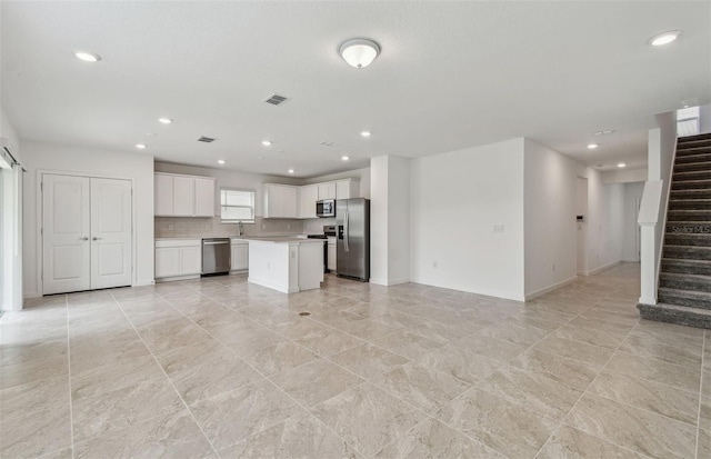 10352 Cross River Trl, Parrish, FL 34219 - unfurnished living room with recessed lighting, stairway, and baseboards