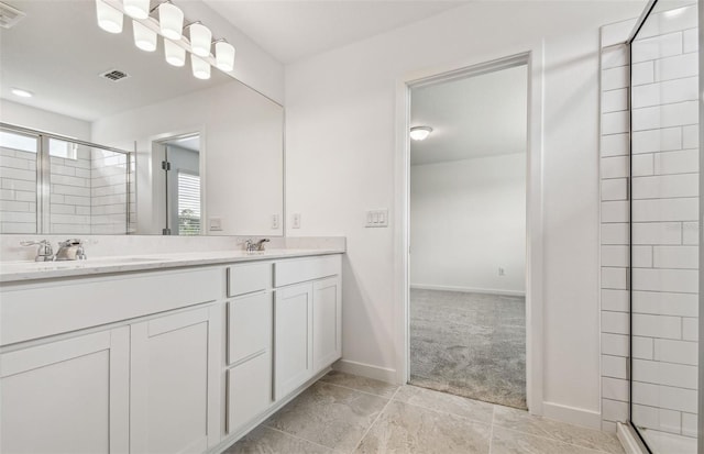10352 Cross River Trl, Parrish, FL 34219 - bathroom featuring a shower stall, double vanity, baseboards, and tile patterned flooring