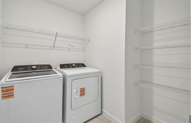 10352 Cross River Trl, Parrish, FL 34219 - laundry room featuring washing machine and clothes dryer and baseboards