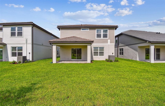 10352 Cross River Trl, Parrish, FL 34219 - back of property with central air condition unit, stucco siding, a lawn, and a patio