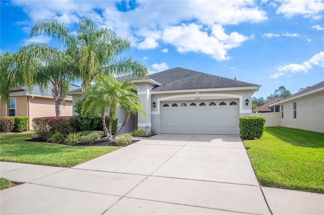 view of front of house featuring an attached garage, concrete driveway, a front yard, and stucco siding