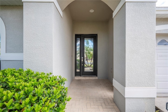 entrance to property featuring stucco siding