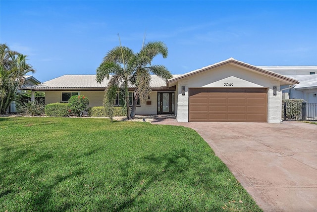 ranch-style house featuring a front lawn and a garage