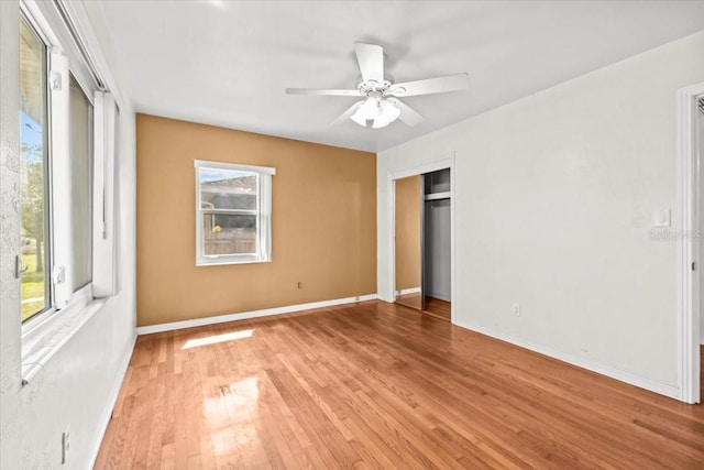 unfurnished bedroom featuring wood finished floors, a ceiling fan, and baseboards