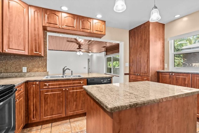 kitchen featuring dishwasher, light stone counters, a sink, and brown cabinets