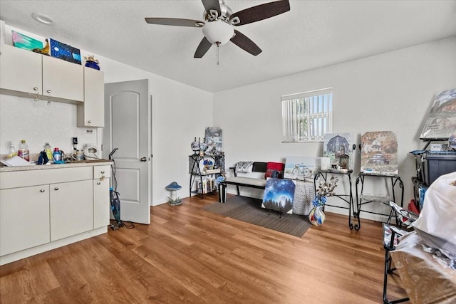 interior space featuring light wood-style floors, ceiling fan, and a textured ceiling