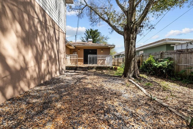 view of yard featuring fence and a wooden deck