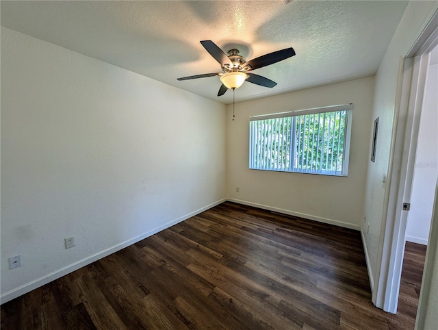 unfurnished bedroom with dark wood-style flooring, baseboards, a ceiling fan, and a textured ceiling
