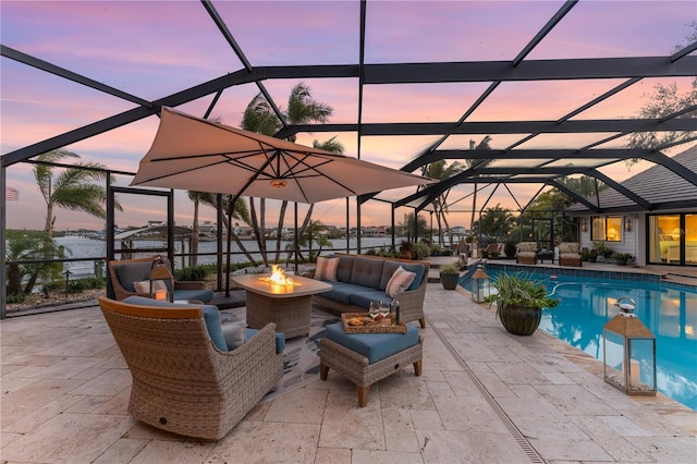 view of patio / terrace featuring glass enclosure, an outdoor pool, and an outdoor living space with a fire pit