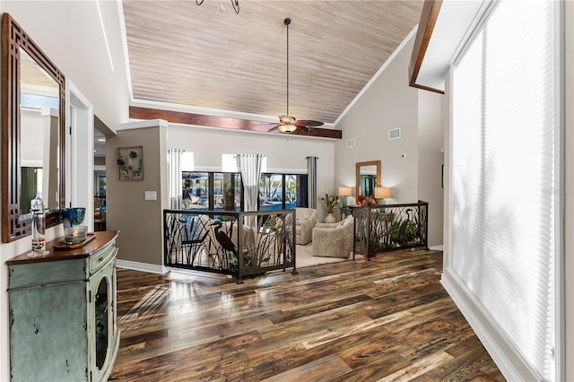 living room with dark wood finished floors, visible vents, high vaulted ceiling, and crown molding