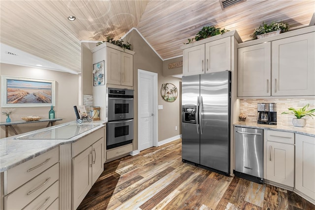 kitchen featuring wood finished floors, lofted ceiling, appliances with stainless steel finishes, wooden ceiling, and backsplash