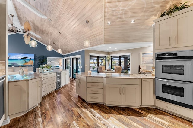 kitchen with beverage cooler, a peninsula, lofted ceiling, wood ceiling, and double oven