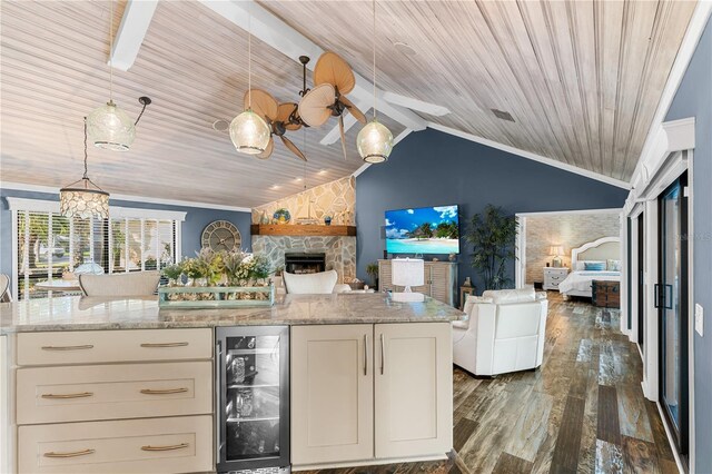 kitchen featuring wine cooler, open floor plan, dark wood-style flooring, and a fireplace