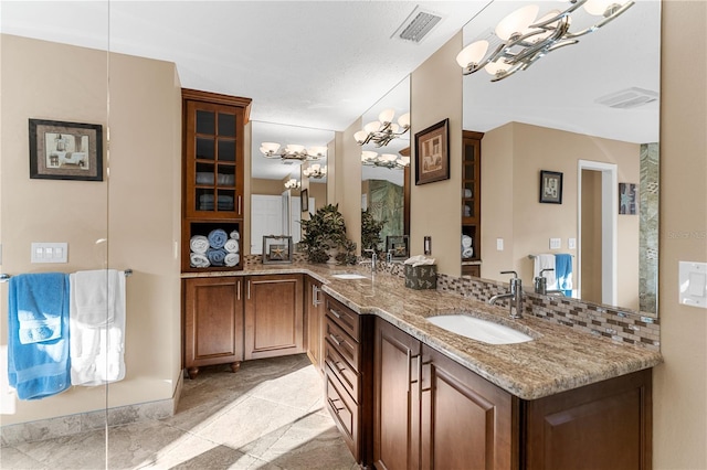 full bath with double vanity, visible vents, and a sink