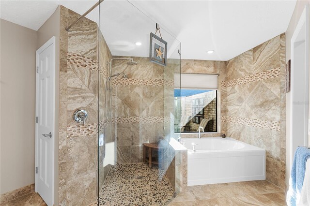 full bathroom with a bath, a stall shower, and tile walls