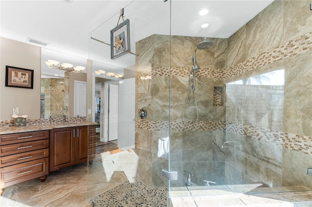 full bath with visible vents, a shower stall, and vanity