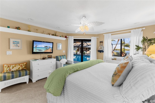 bedroom with a ceiling fan, access to exterior, carpet flooring, and crown molding