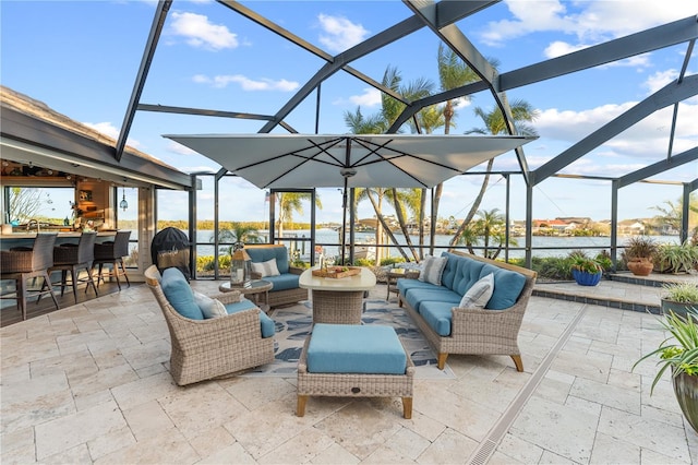 view of patio / terrace featuring glass enclosure, an outdoor hangout area, and outdoor dry bar