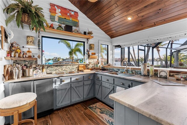 kitchen with backsplash, gray cabinets, wooden ceiling, dark wood-style floors, and a sink