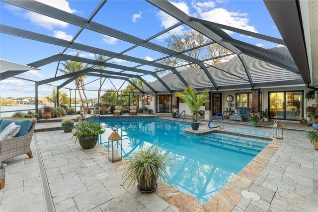 pool with a patio area and glass enclosure