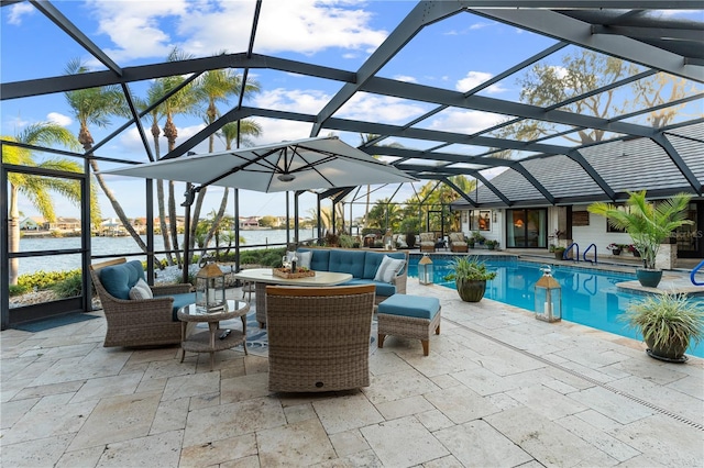 pool with a patio, a lanai, outdoor lounge area, and a water view