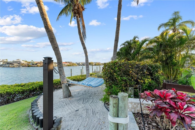 view of patio / terrace featuring a water view and a dock