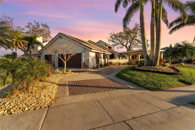 view of front of home featuring decorative driveway and a garage