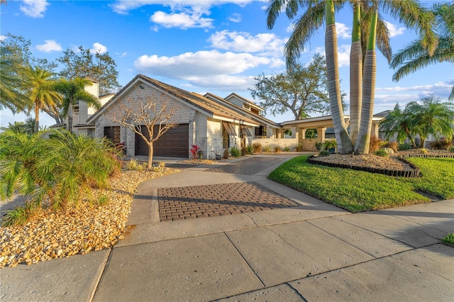 view of front of property with decorative driveway and an attached garage